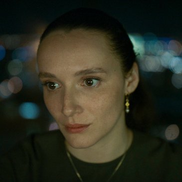 Closeup of woman's face with hair pulled back