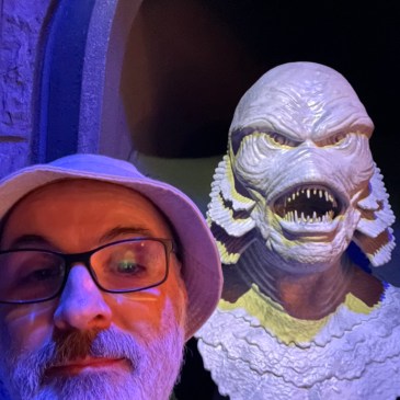 Selfie of author in front of a bust of the creature from the black lagoon