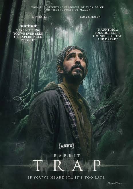 Rabbit trap poster featuring man in forest looking up